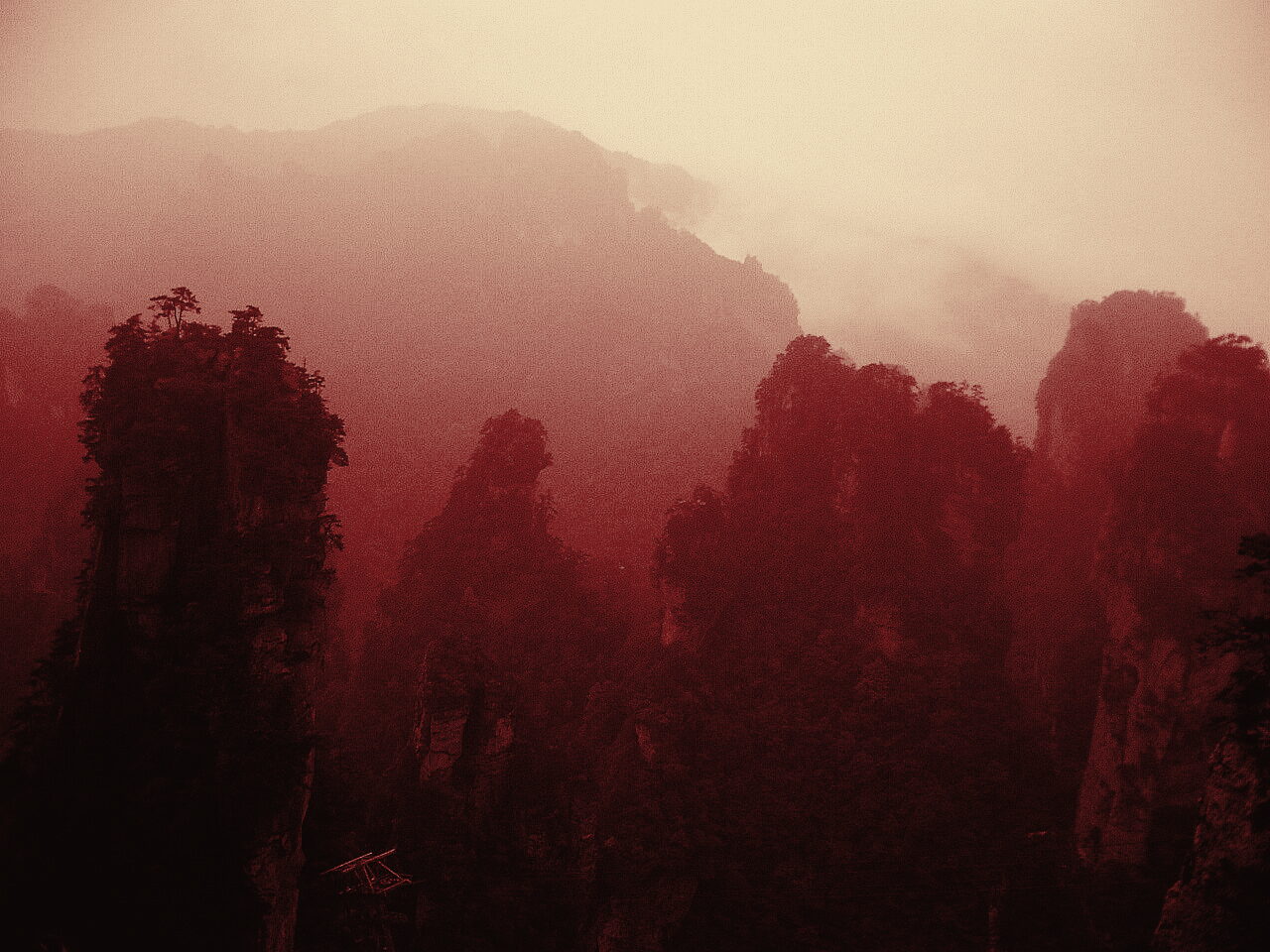 Sandstone pillars rising through mist in Zhangjiajie, duotone film still